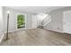 Inviting living room boasting hardwood floors, a bright window, and easy access to the staircase and front door at 315 73Rd Ave. N # 2, Myrtle Beach, SC 29572