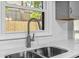 Close up of kitchen sink, faucet, white countertop, and subway tile backsplash at 315 73Rd Ave. N # 2, Myrtle Beach, SC 29572