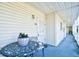 Cozy balcony with a table, chair and a potted flower, offering a charming outdoor space at 3308 S Ocean Blvd. # 2_B, North Myrtle Beach, SC 29582