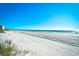 Expansive beach view showing the shoreline and distant buildings under a clear blue sky at 3308 S Ocean Blvd. # 2_B, North Myrtle Beach, SC 29582