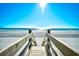 Serene beach view with a wooden walkway leading to the sandy shore and ocean at 3308 S Ocean Blvd. # 2_B, North Myrtle Beach, SC 29582