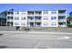 Exterior view of a condo building featuring multiple balconies and street access at 3308 S Ocean Blvd. # 2_B, North Myrtle Beach, SC 29582
