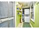 Functional laundry area with stacked washer and dryer, shelving, and window for light at 3308 S Ocean Blvd. # 2_B, North Myrtle Beach, SC 29582