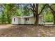 View of the home's rear exterior with a tree in the yard at 3519 Cates Bay Hwy., Conway, SC 29527