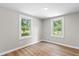 A bedroom with hardwood floors, two windows providing ample natural light at 3519 Cates Bay Hwy., Conway, SC 29527