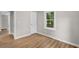 A room featuring modern hardwood floors, natural light from a window and an interior door at 3519 Cates Bay Hwy., Conway, SC 29527