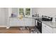 Kitchen featuring stainless steel appliances, granite countertops, white cabinets, and wood-look flooring at 3519 Cates Bay Hwy., Conway, SC 29527