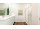 Bright bathroom with double sinks, white cabinetry, and a glass-enclosed shower at 3562 Ashridge Way, Conway, SC 29526