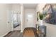 Inviting entryway featuring wood floors, neutral paint, and stylish decor with a view to a bedroom at 3562 Ashridge Way, Conway, SC 29526