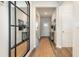 Bright entryway with wood-look floors and modern decor that leads to the home's main living area at 3562 Ashridge Way, Conway, SC 29526