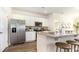 Modern kitchen featuring white cabinets, stainless steel appliances, and a granite countertop island with seating at 3562 Ashridge Way, Conway, SC 29526