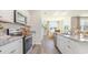 Bright kitchen with white cabinets, stainless steel appliances, and a view into the dining area at 3562 Ashridge Way, Conway, SC 29526