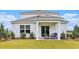 Charming backyard patio with seating and well-manicured landscaping under a blue sky at 3579 Ashridge Way, Conway, SC 29526