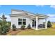 Inviting backyard featuring a covered patio with comfortable seating and lush greenery at 3579 Ashridge Way, Conway, SC 29526