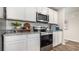 Modern kitchen featuring stainless steel appliances, white cabinets, and granite countertops at 3579 Ashridge Way, Conway, SC 29526