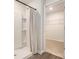 Modern shower with white tile and convenient shelving, with an adjacent walk-in closet at 3579 Ashridge Way, Conway, SC 29526