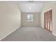 A bright bedroom with neutral carpet, a window, and a closet with louvered doors at 3700 Golf Colony Lane # 25G, Little River, SC 29566