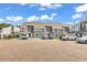 A townhouse complex featuring ample parking and exterior gray color scheme at 3700 Golf Colony Lane # 25G, Little River, SC 29566