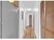 Bright hallway with wood-look flooring features closet and access to other rooms at 3700 Golf Colony Lane # 25G, Little River, SC 29566