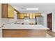 Open kitchen features white countertops, yellow cabinets, and stainless-steel appliances at 3700 Golf Colony Lane # 25G, Little River, SC 29566