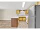 Open kitchen with white countertops, yellow cabinets, and stainless-steel appliances at 3700 Golf Colony Lane # 25G, Little River, SC 29566
