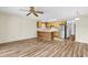 Open concept living space showcasing the wood flooring and kitchen with stainless steel appliances at 3700 Golf Colony Lane # 25G, Little River, SC 29566