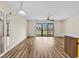 Bright living room with hard wood floors and sliding glass doors to a balcony at 3700 Golf Colony Lane # 25G, Little River, SC 29566