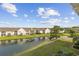 Scenic backyard view overlooking a tranquil pond, surrounded by lush greenery and blue skies at 3983 Forsythia Ct. # 301, Myrtle Beach, SC 29588