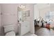Bathroom with sink, toilet, and a view to a bedroom space with hardwood floors at 3983 Forsythia Ct. # 301, Myrtle Beach, SC 29588