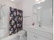 Clean bathroom with shower, toilet, and vanity with generous lighting at 3983 Forsythia Ct. # 301, Myrtle Beach, SC 29588