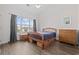 Bedroom featuring wood-look floors, a large window, and ample natural light at 3983 Forsythia Ct. # 301, Myrtle Beach, SC 29588