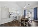 Bright kitchen with white cabinetry, stainless steel appliances, and an adjacent dining area with hardwood floors at 3983 Forsythia Ct. # 301, Myrtle Beach, SC 29588