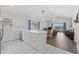 Bright and open kitchen with white cabinets, tiled floors, stainless steel appliances, and access to a dining and living space at 3983 Forsythia Ct. # 301, Myrtle Beach, SC 29588