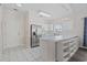 Bright kitchen features white cabinets, tiled floors, stainless steel refrigerator, and a convenient breakfast bar at 3983 Forsythia Ct. # 301, Myrtle Beach, SC 29588