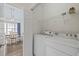 Functional laundry room featuring a washer, dryer, and wire shelving at 3983 Forsythia Ct. # 301, Myrtle Beach, SC 29588