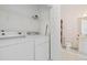 Laundry room adjacent to the bathroom, complete with washer, dryer, and storage space at 3983 Forsythia Ct. # 301, Myrtle Beach, SC 29588