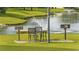 Charming outdoor seating area featuring a grill and scenic pond views, perfect for relaxed gatherings at 3983 Forsythia Ct. # 301, Myrtle Beach, SC 29588