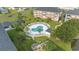 Aerial view of community pool with lounge chairs, mature palms, and lush lawn at 3983 Forsythia Ct. # 301, Myrtle Beach, SC 29588