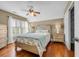 Comfortable bedroom with hardwood floors, a ceiling fan, and a large window at 4232 Pointer Ct., Myrtle Beach, SC 29579