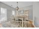 Elegant dining room with a rustic wood table, stylish chandelier, and built-in shelving at 4232 Pointer Ct., Myrtle Beach, SC 29579