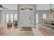 Bright foyer with tiled floors, a decorative front door with sidelights, and views of the living and dining areas at 4232 Pointer Ct., Myrtle Beach, SC 29579