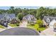 Front exterior of a two-story brick home with a well-manicured lawn and a circular driveway at 4232 Pointer Ct., Myrtle Beach, SC 29579