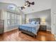 Serene main bedroom with hardwood floors, a vaulted ceiling, large windows, and a comfortable bed at 4232 Pointer Ct., Myrtle Beach, SC 29579