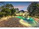 Outdoor in-ground pool with an accent light and brick surround at dusk at 4232 Pointer Ct., Myrtle Beach, SC 29579