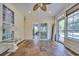 Bright sunroom with tile flooring, ceiling fan, and sliding glass doors leading to a pool area at 4232 Pointer Ct., Myrtle Beach, SC 29579