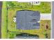 Aerial view of a well-maintained home with a green lawn, fenced backyard, and an outdoor seating area at 446 Rycola Circle, Surfside Beach, SC 29575