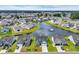 Aerial view of a neighborhood with a pond, fountain, and manicured lawns, offering a picturesque community setting at 446 Rycola Circle, Surfside Beach, SC 29575
