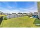 The backyard offers serene lake views, a black fence, and outdoor seating, perfect for relaxation and entertaining at 446 Rycola Circle, Surfside Beach, SC 29575