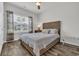 Comfortable bedroom with wood-look flooring, ceiling fan, and a sun-filled window view at 446 Rycola Circle, Surfside Beach, SC 29575