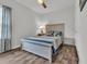 Inviting bedroom with a ceiling fan, wood-look floors, and a brightly lit window at 446 Rycola Circle, Surfside Beach, SC 29575